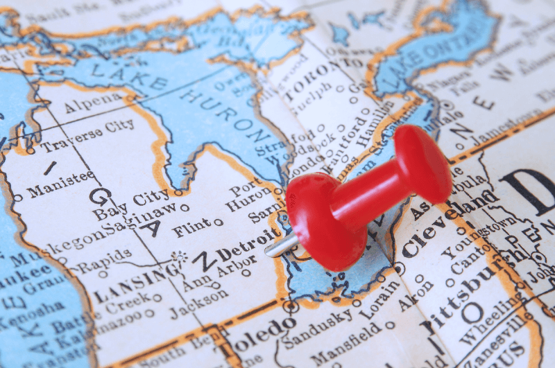 A zoomed in map of Michigan with a thumbtack inserted.