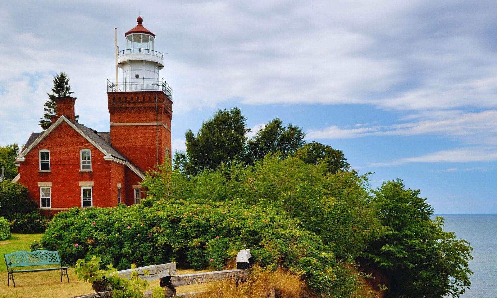 Big bay lighthouse, a multistory brick structure on a cliff with a square light tower.