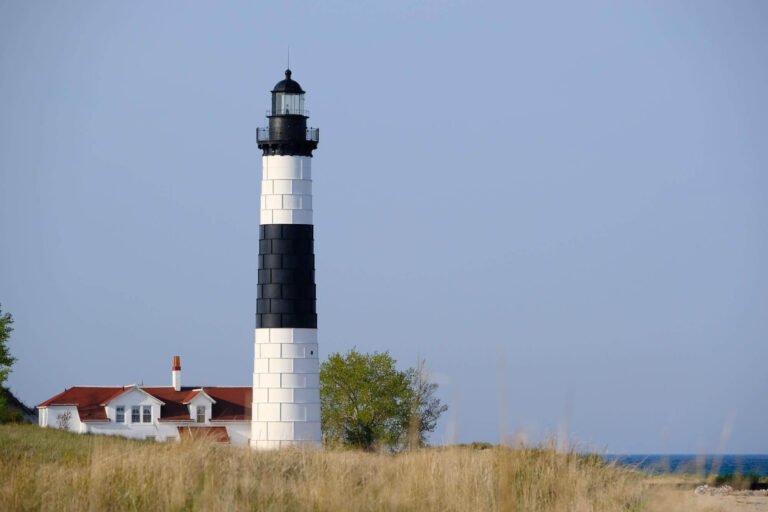 Big sable point lighthouse, a large, conical lighthouse painted with thick horizontal black and white lines.