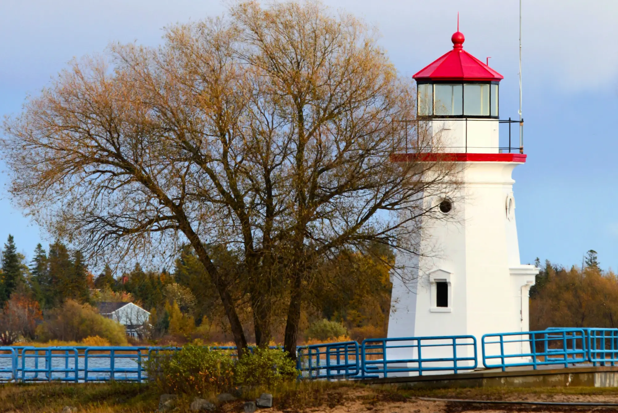 Cheboygan Crib Light, a short, white, octagonal lighthouse with a red cap.