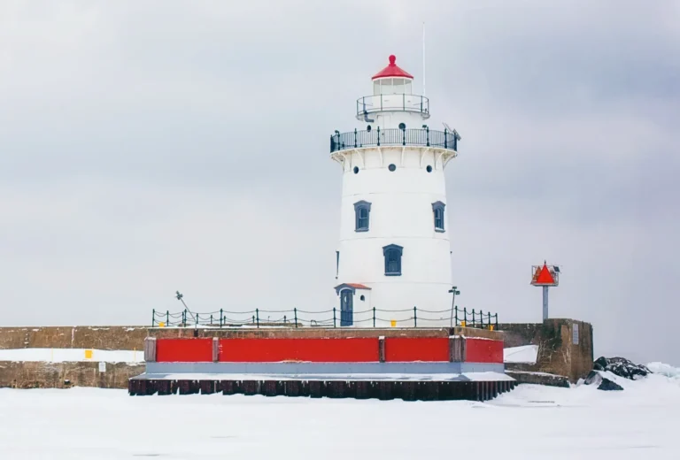 Harbor Beach Lighthouse, a stout conical structure with a red roof.